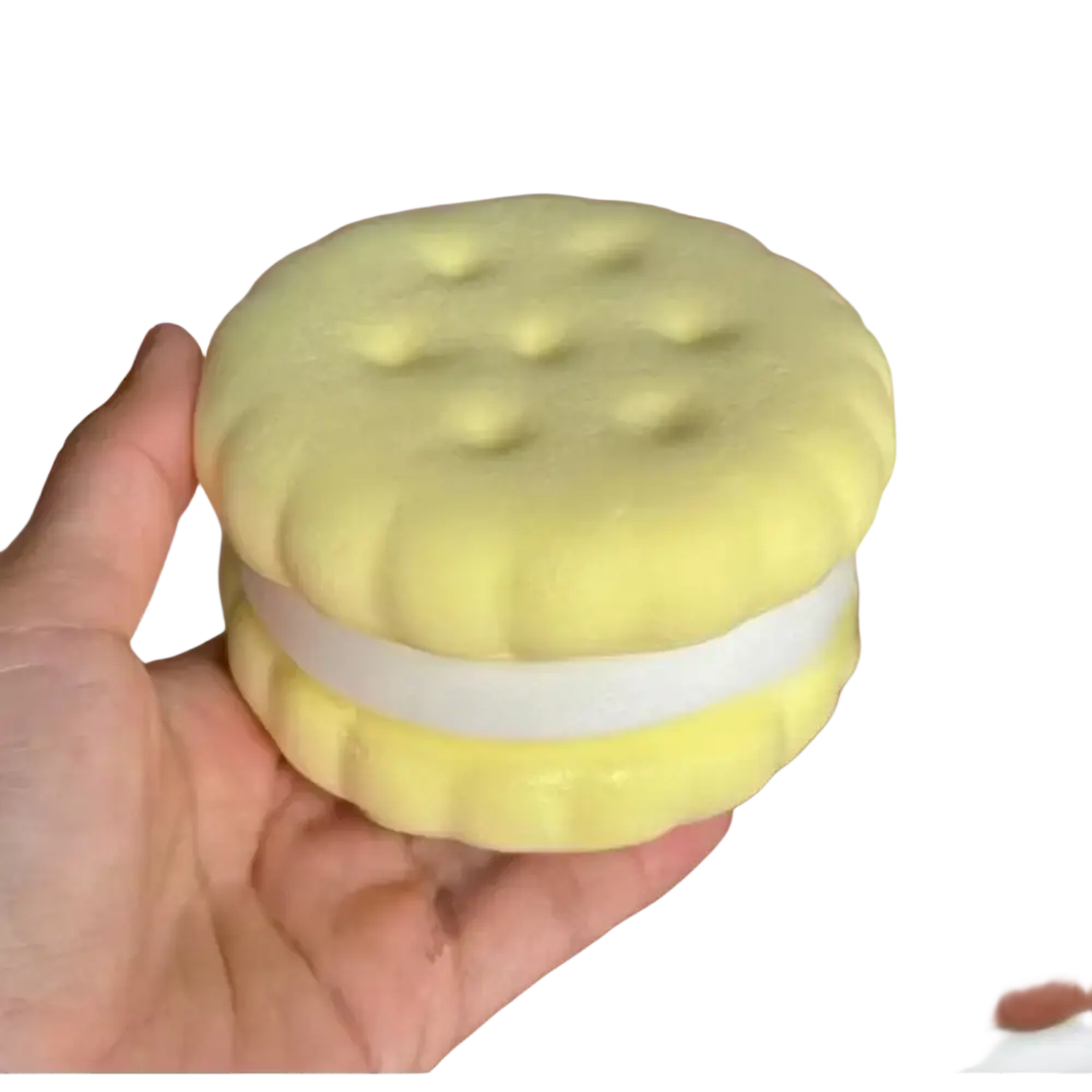A soft yellow silicone slow rising big cookie squishy toy with a white filling and textured round top