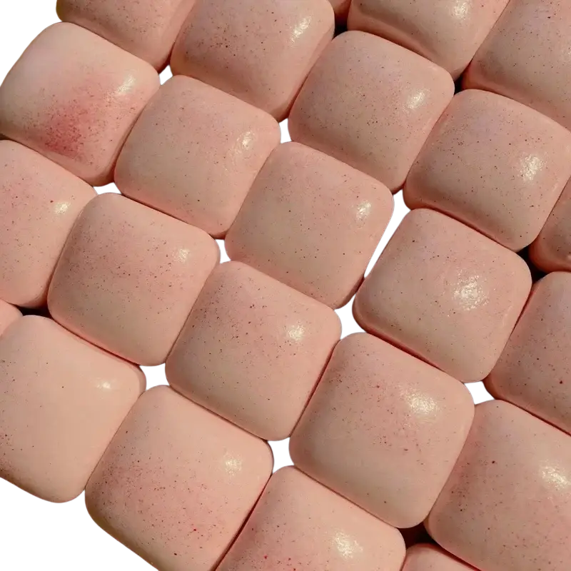Pink speckled gum squares arranged in a grid of slow rising squishy mini toast fidget toy pieces