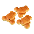 Three golden brown slow rising toast fidget toys with cute eyes on a wooden plate for stress relief and desktop decoration
