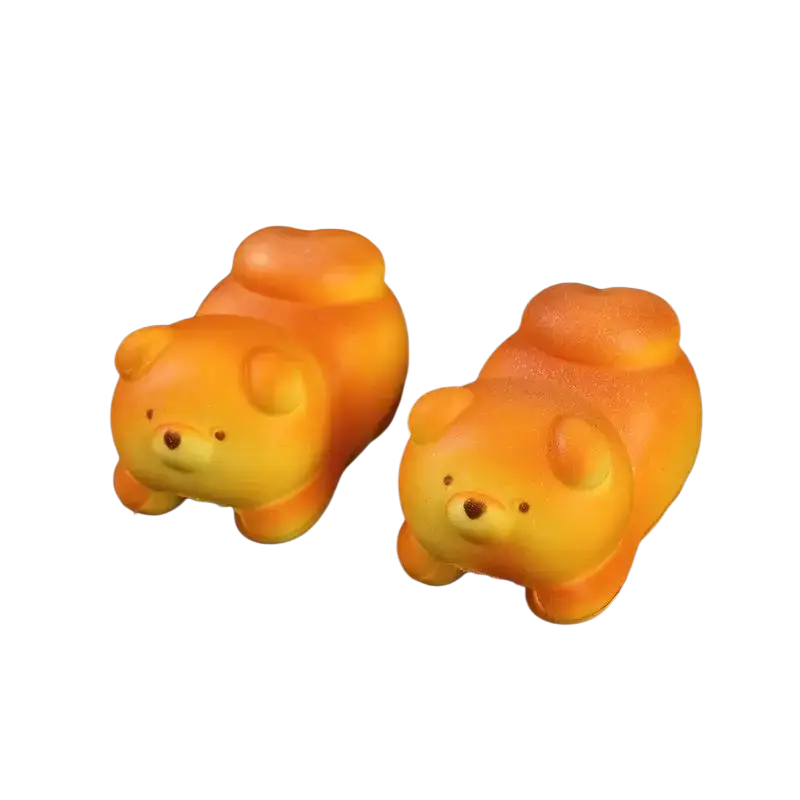 Two orange and yellow squishy dog-shaped slow rising toast fidget toys designed for stress relief and daily stress management