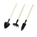 Set of three small gardening tools with black metal heads and cream-colored wood handles including a garden shovel