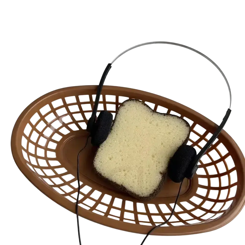 A small headphones retro wired over ear portable black shown with a brown plastic basket containing a slice of bread