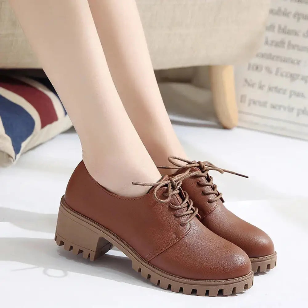 Brown leather women’s lace up oxford shoes with chunky textured platform sole shown from the side