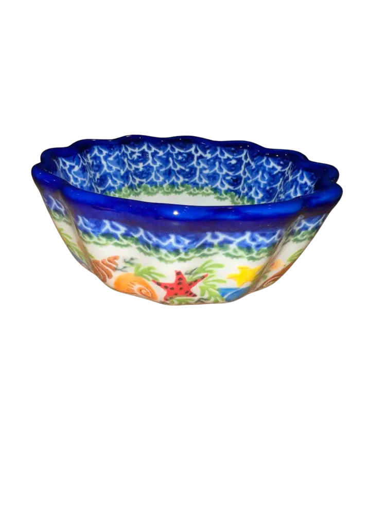 Hand-painted sealife ceramic scalloped bowl with vibrant starfish fish and seaweed design on white background