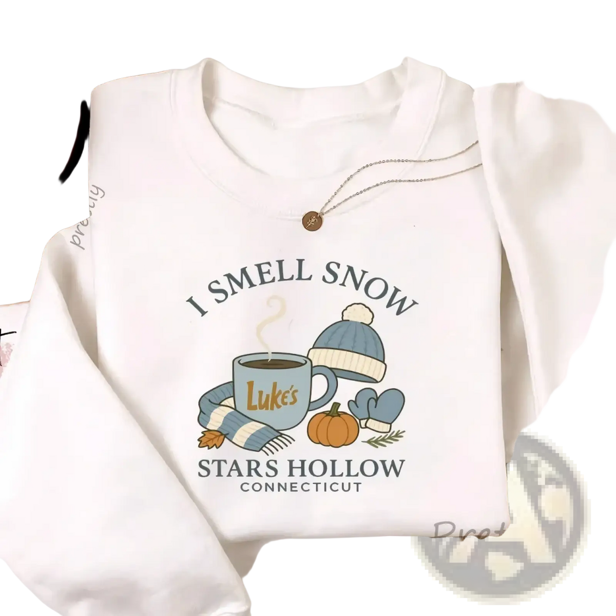 White crewneck sweatshirt featuring cozy autumn graphic with i smell snow text and stars hollow connecticut details