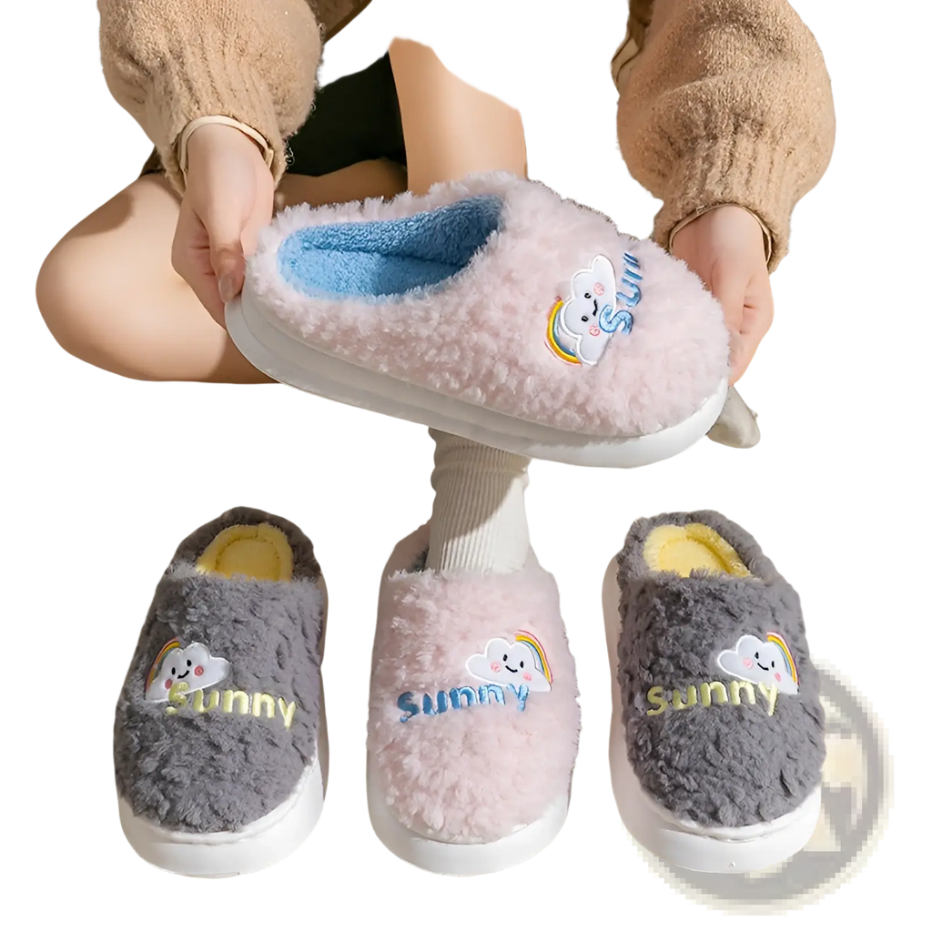 Pink fluffy cotton slippers with blue interior and embroidered sunny cloud and rainbow design for indoor use