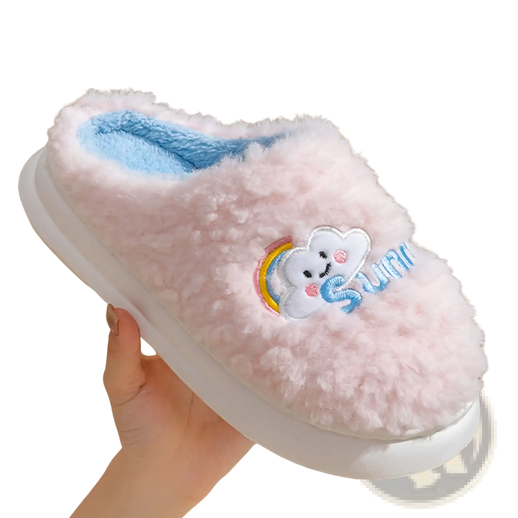 Pink fluffy slippers with embroidered smiling cloud and rainbow design featuring soft plush material and light blue lining