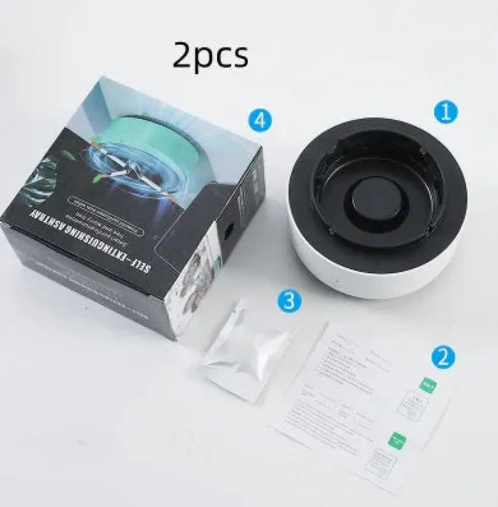 Black and white circular self-extinguishing portable ashtray with central recessed area for smoke purification