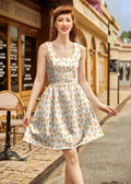 A sleeveless knee-length vintage carnival snacks fit and flare cotton dress in soft cream with pastel ice cream and pretzel pattern