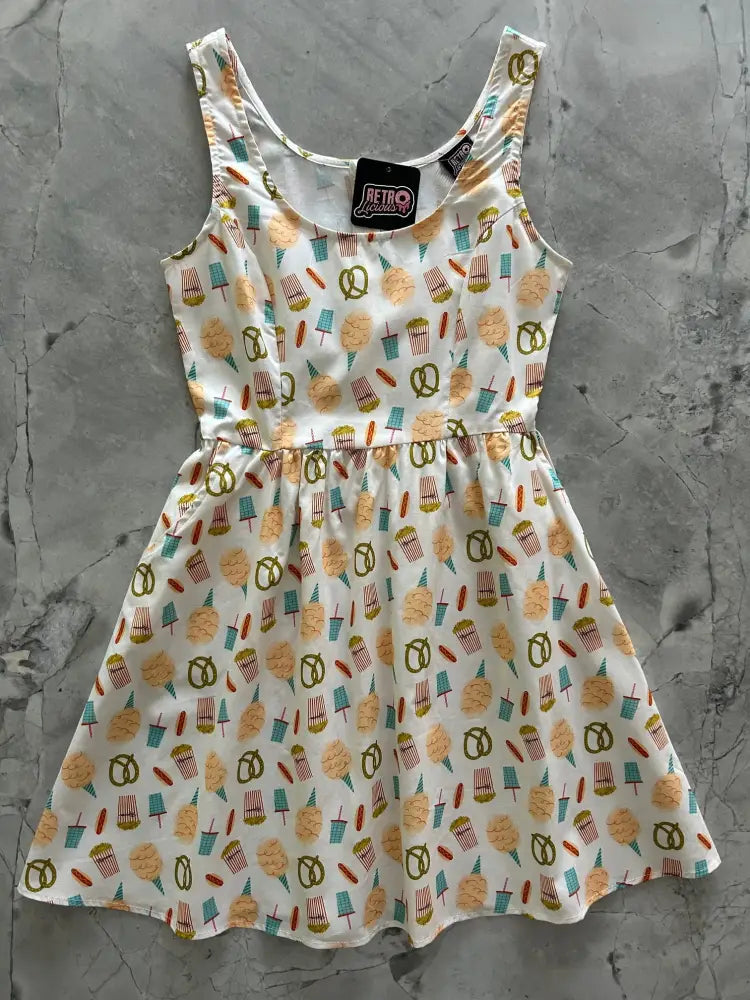 White sleeveless fit and flare cotton dress with playful pastel ice cream cones pretzels and popsicles pattern vintage style