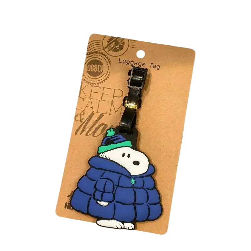 Snoopy luggage tag in a blue puffer jacket with green hat and black clip for suitcase ID holder use