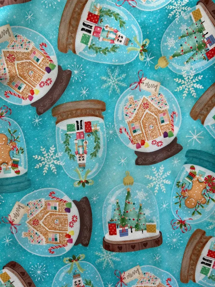 Blue cotton skater skirt with festive snow globes featuring gingerbread houses christmas trees and nutcrackers pattern