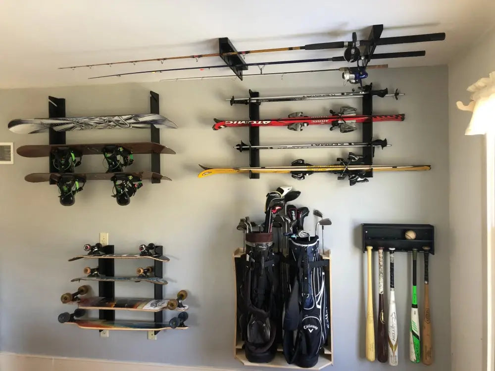 Handcrafted minimalist snowboard wall mount display rack holding black and white Callaway golf bags on a wall rack