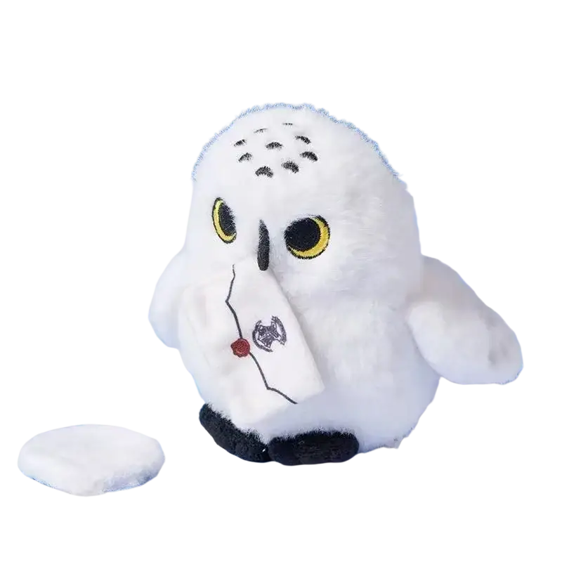 White plush snowy owl toy with yellow eyes black beak and embroidered letter wearing a scarf