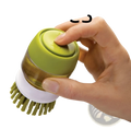 Soap dispensing dish brush with green and white dual-sided soft bristles and non slip storage base