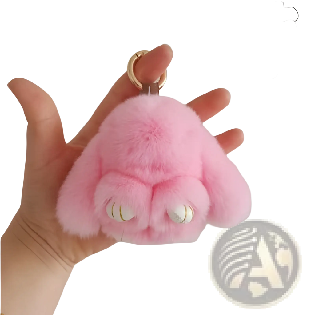 Soft fluffy bunny faux fur plush keychain accessory in pink with white eyes and a gold-colored ring attachment