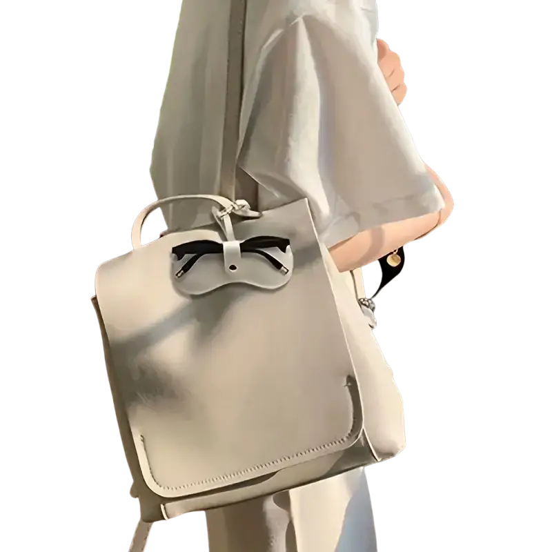 Soft leather off-white eyeglass case with strap featuring a sleek design and black bow accent for stylish eyewear accessories