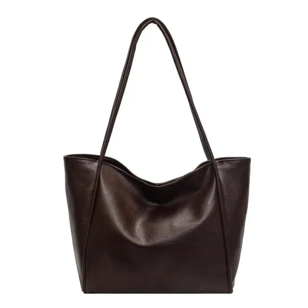 Dark brown large faux leather minimalist commuter tote bag with long handles and soft slouchy silhouette