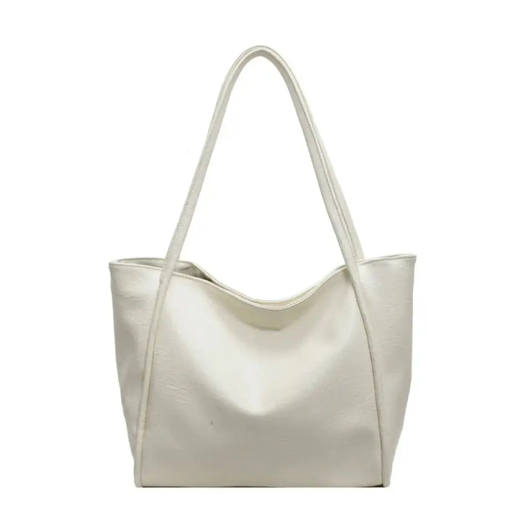 Cream-colored large commuter tote bag made of smooth glossy faux leather with a minimalist design