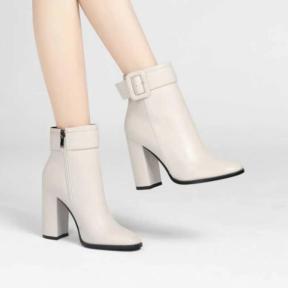 Cream-colored soft leather ankle boots for women featuring a block heel and buckle detail