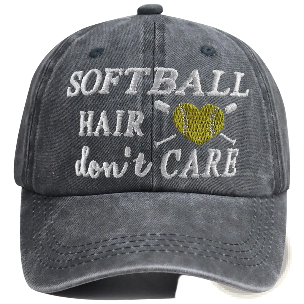 A dark gray distressed cotton baseball cap with embroidered white softball hair dont care text and yellow heart softball design