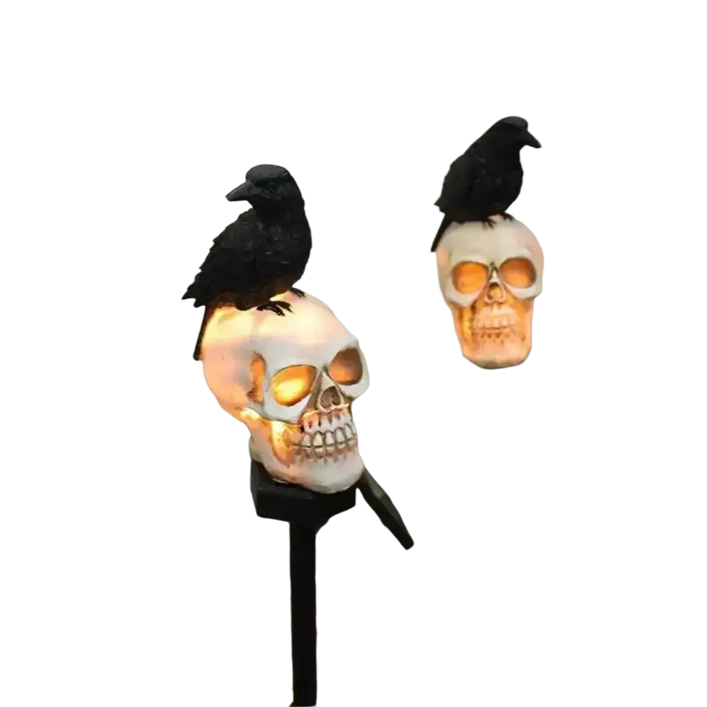 Solar skull garden stake featuring black crows perched on illuminated white skulls with glowing orange eye sockets