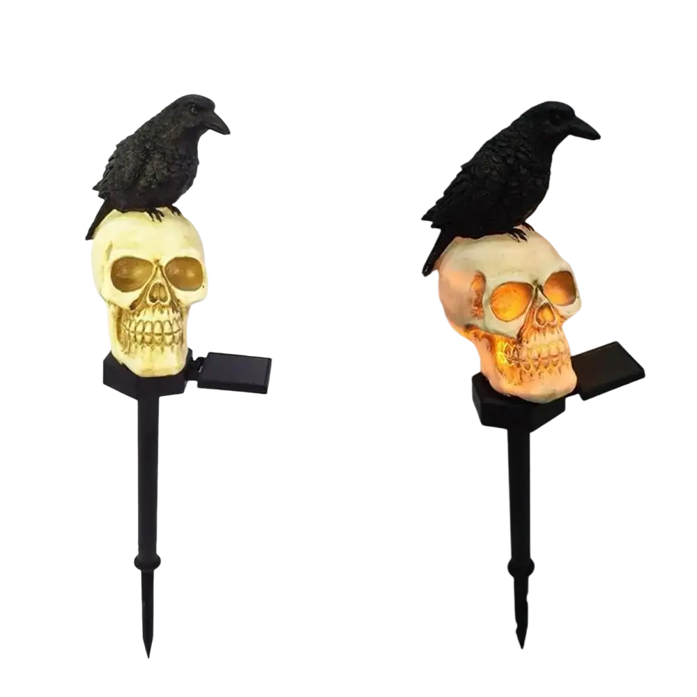 Black crow perched on a glowing beige skull solar garden light with integrated black stake for halloween decoration