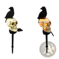 Solar skull crow garden stake halloween light features a black crow on a white skull with gold accents and orange glow
