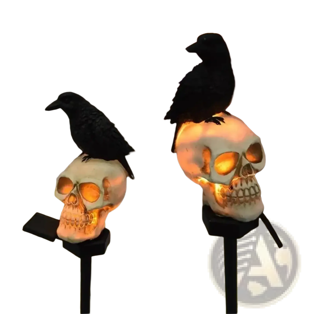 White skull-shaped solar garden stake lights with glowing orange interiors and black crow decorations for halloween