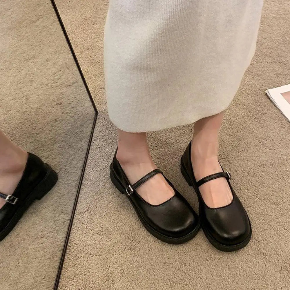 Black leather women’s french vintage mary jane flats with square toe thick sole and silver buckle closure