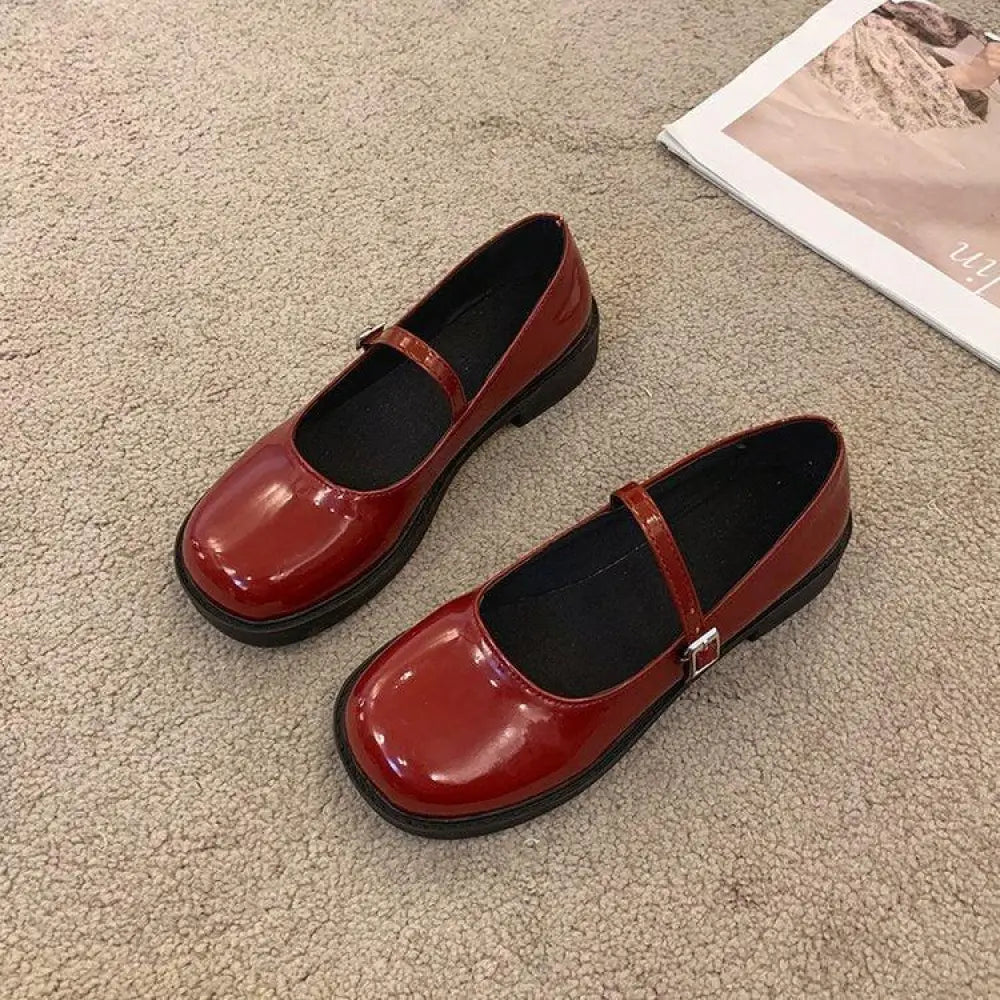 Women’s french vintage leather square toe mary jane flats in red patent leather with thick black sole and silver buckle