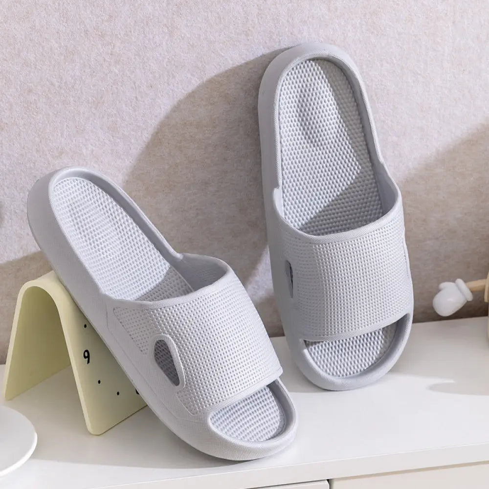 Light gray mesh thick sole non slip cushioned home slides with a breathable textured design and modern silhouette