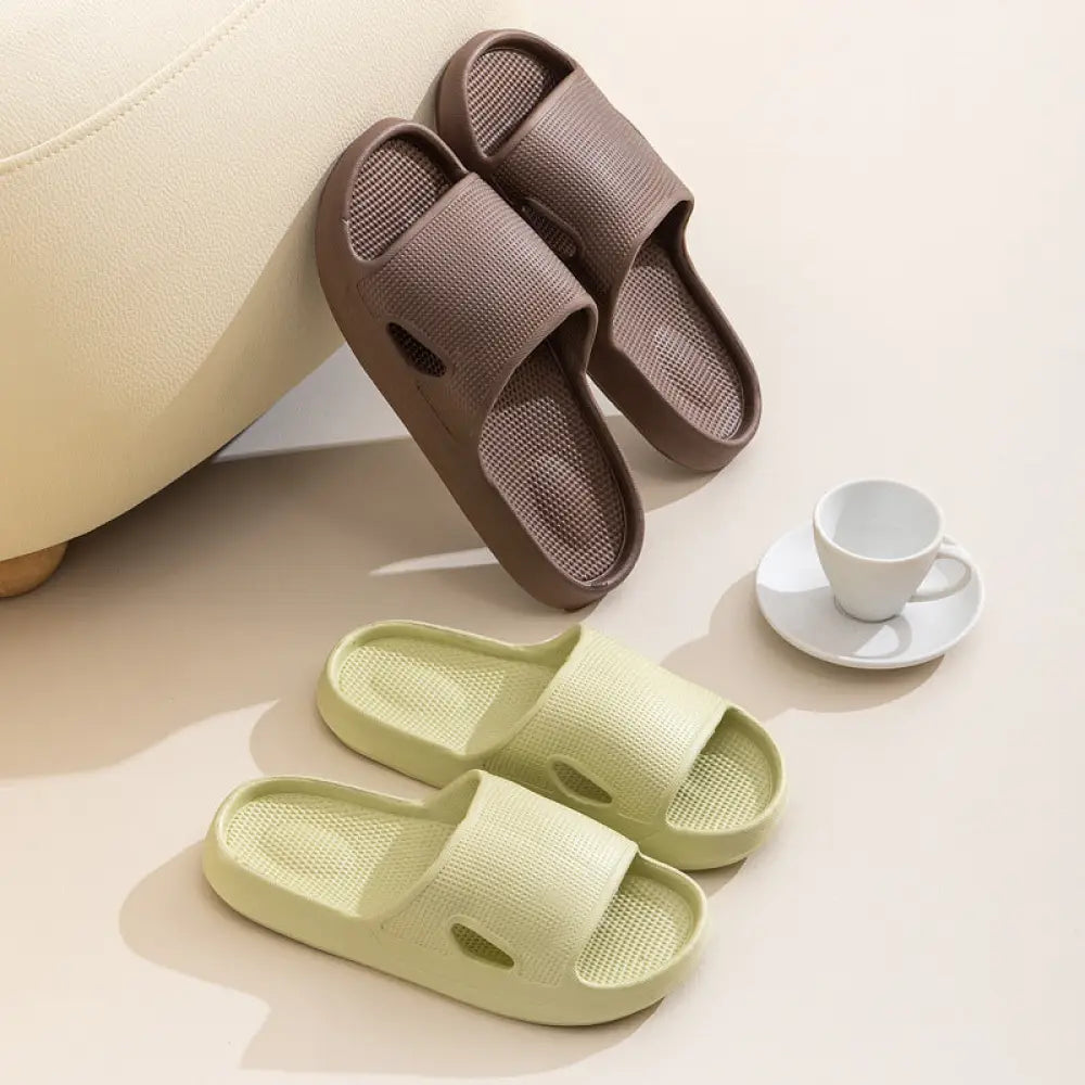 Thick sole non slip cushioned home slide sandals in brown and light green plastic with textured soles and cutout designs