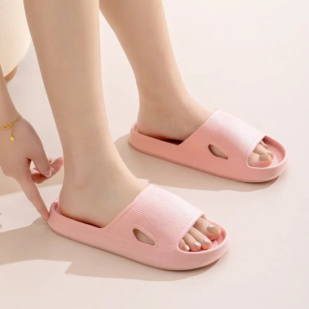 Pink plastic thick sole non slip cushioned home slide sandals with textured upper and cutout toe design