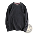 Black solid color washed pullover long sleeve t-shirt with subtle ribbed collar trim and small brand tag at neckline