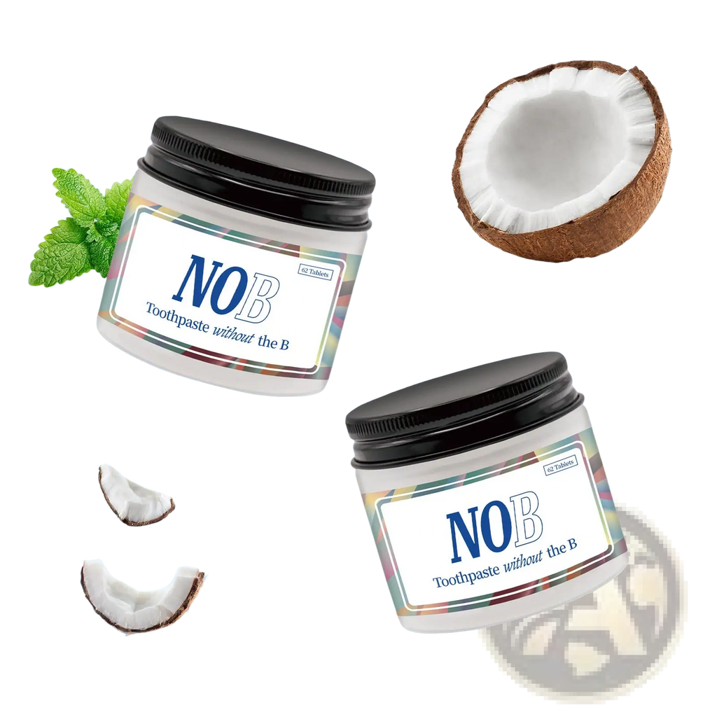 Two white jars of nob solid toothpaste tablets with colorful labels surrounded by coconut pieces and mint leaves