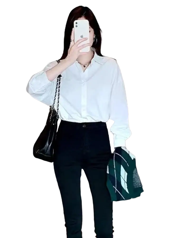 Black leather shoulder bag with silver chain strap paired with a solid white basic shirt oversized casual button up blouse