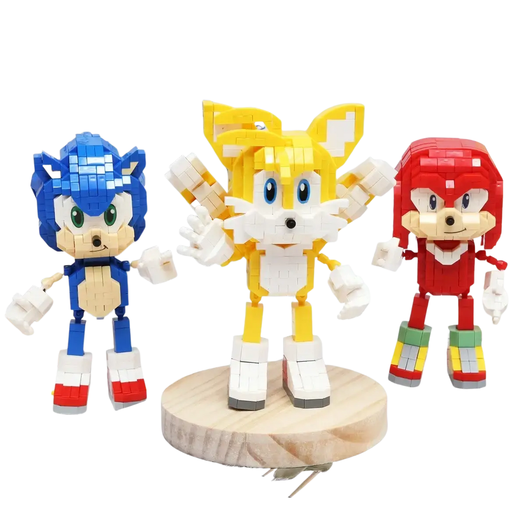 Three colorful sonic building block figures in blue, yellow, and red standing on a wooden display base