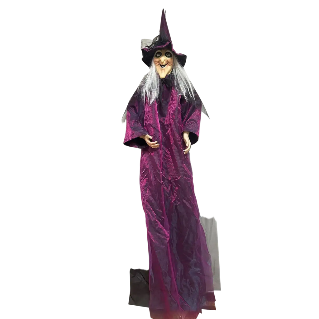 A tall sound activated halloween witch prop in a long purple velvet robe and black hat hanging as a ghost figure