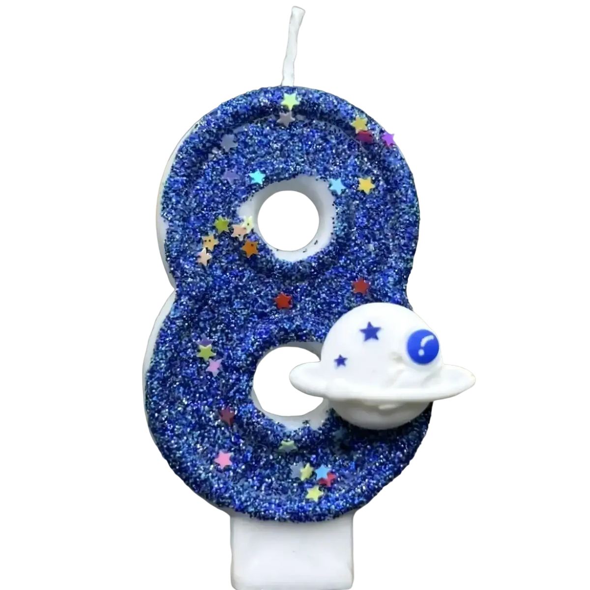 A blue glittery number eight birthday candle with colorful star sprinkles and a white spaceship charm for planetary party cake