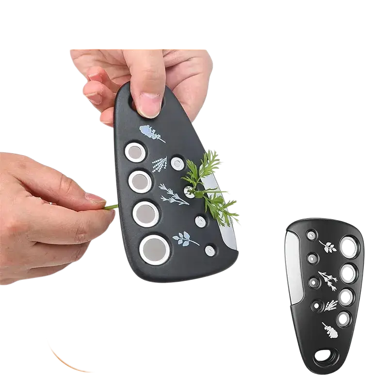 Black herb stripper with white circular cutouts and leaf decals in a space saving kitchen gadget set with bottle opener and pizza cutter