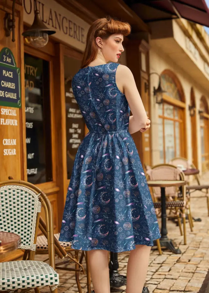 Navy celestial 1950s vintage sleeveless cotton A-line dress with pockets featuring moons stars and planets pattern