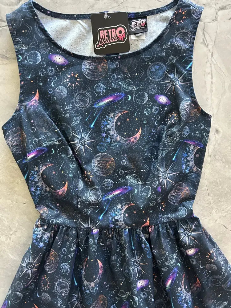 Navy sleeveless 1950s vintage A-line cotton dress with pockets featuring a vibrant cosmic print of planets moons stars and galaxies