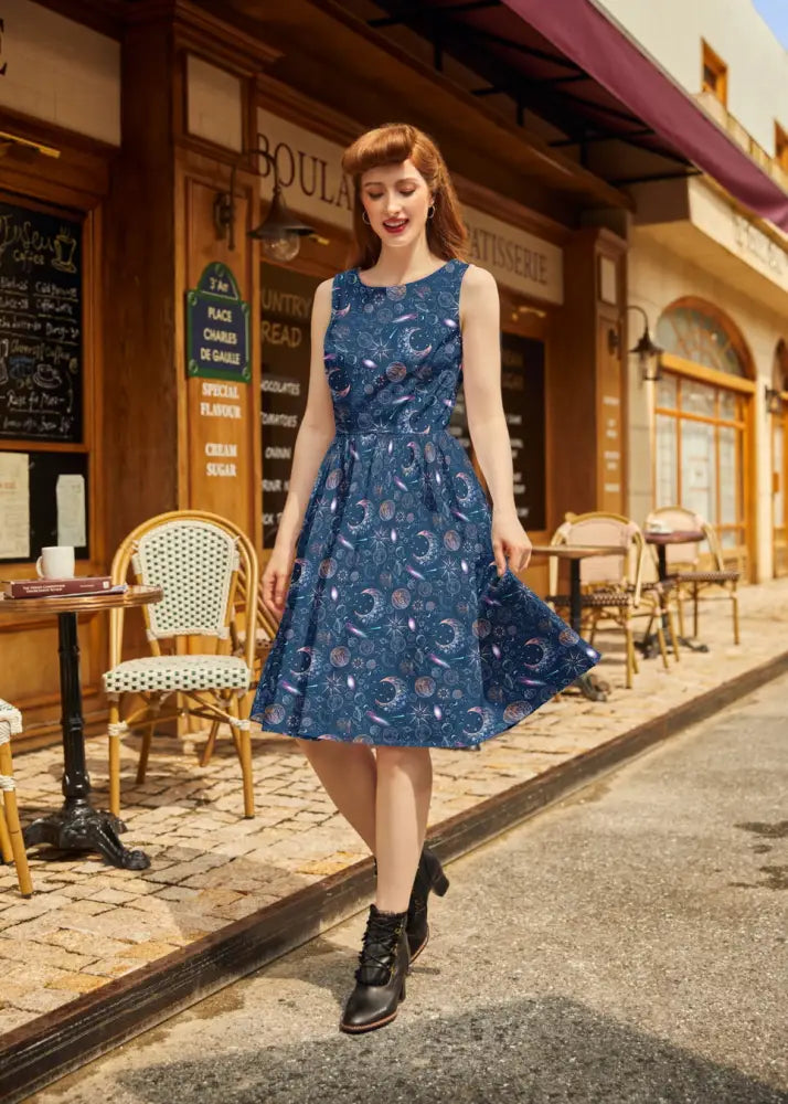 Navy celestial 1950s vintage a-line cotton dress with pockets featuring a fitted bodice and flared skirt with moons and stars pattern