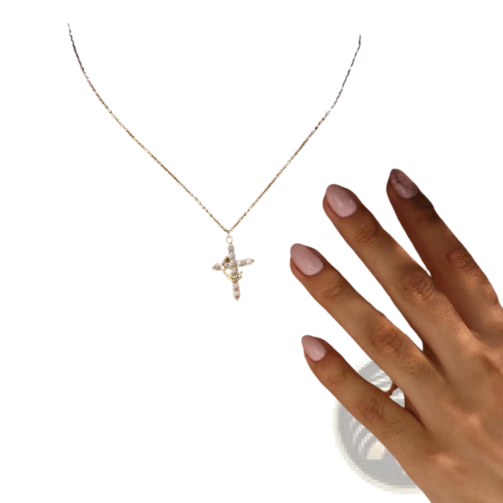 Gold-toned cross pendant necklace with sparkling clear crystals on a delicate chain in the sparkling layered crown design