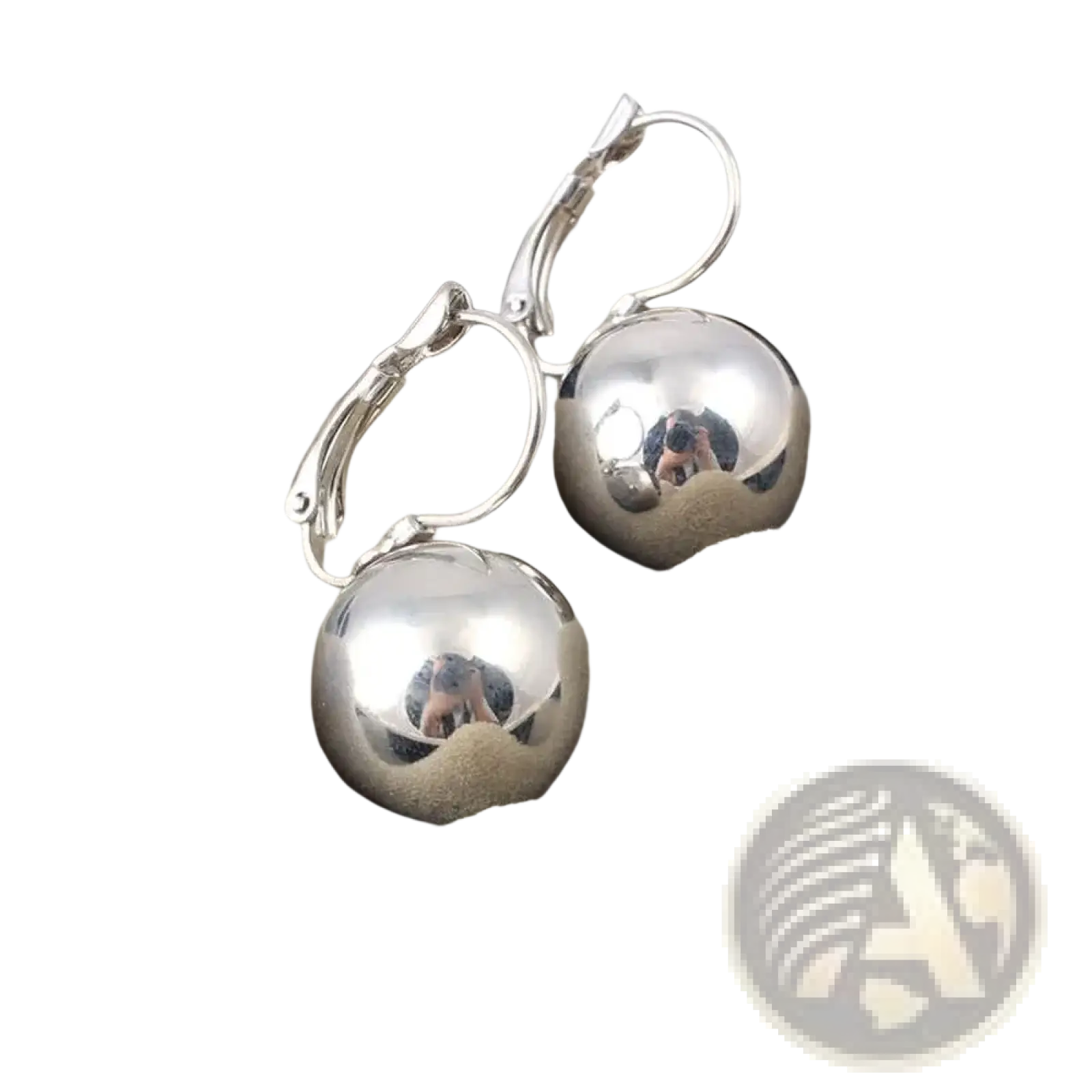 Shiny silver spherical ball dangle earrings with polished metallic finish and lever-back clasps