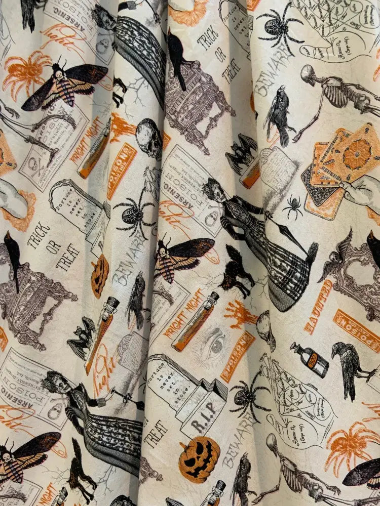 Spooky dorris vintage pleated halloween skirt with pockets featuring black orange and beige fabric with spiders skulls bats and tombstones