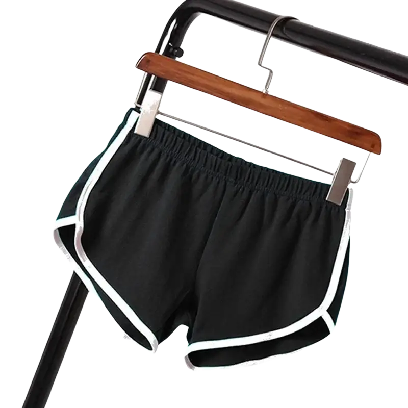 Black sports shorts women with elastic waist and white trim hanging on wooden hanger for casual athletic use