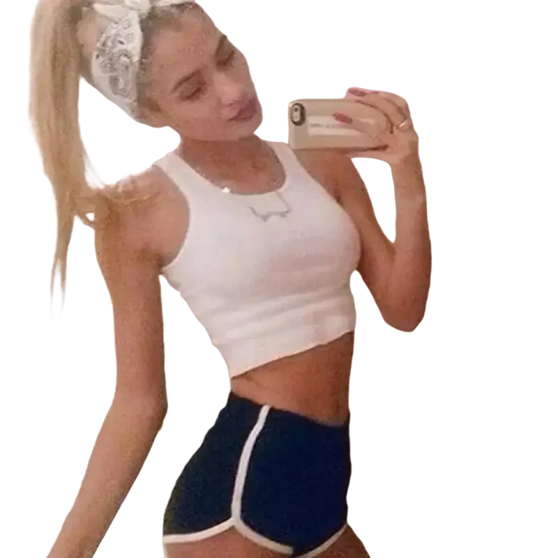 White cropped tank top with subtle silver logo paired with women sports shorts featuring elastic waist for casual athletics