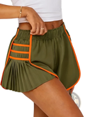 Sporty high waisted olive green pleated shorts with bold orange contrast trim and side slits ideal for activewear